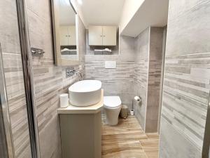 a bathroom with a toilet and a sink and a mirror at CasUccia, nel cuore del centro storico di Gallipoli in Gallipoli +20 photos