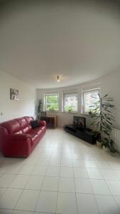 een woonkamer met een rode bank en een open haard bij Apartment Lela in Pula