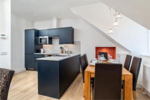 a kitchen and dining room with a table and chairs at Remodelled Luxury 3 Bed Apartment in Aberdeen +7 photos