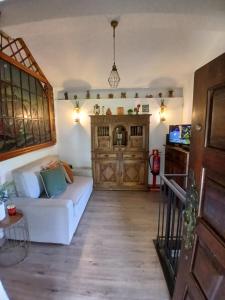 a living room with a white couch and a fireplace at Casa Colmeia in Esposende
