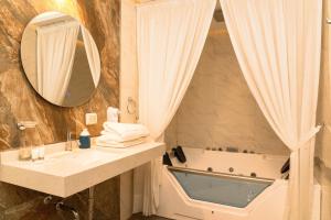 a bathroom with a tub and a sink and a mirror at Hotel Terra by Refugio Ecológico in Arequipa +57 photos