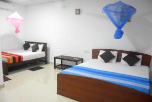 a bedroom with a bed and a couch in it at CFC Holiday Home in Anuradhapura
