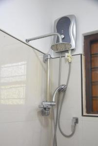a shower in the corner of a bathroom at CFC Holiday Home in Anuradhapura +27 photos