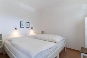 Ένα ή περισσότερα κρεβάτια σε δωμάτιο στο Villa Anna II App 71