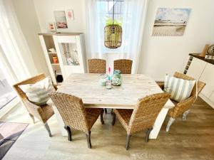 a dining room with a wooden table and chairs at Haus Lieblingsquartier in Tating +25 photos