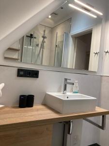 a bathroom with a sink and a mirror at Wohnung Wanlik Hüs in St. Peter-Ording +10 photos