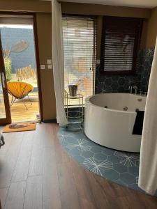 a large bathroom with a tub in the middle of a room at Studio bisou bisou in Merlimont