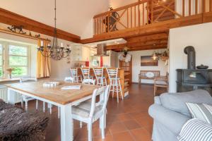 a kitchen and living room with a wooden table and chairs at Friederikenhof in St. Peter-Ording