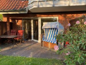un portico con una grande sedia a strisce blu e bianche di Wohnung Wiesenblick Whg 1 a Böhl Altre 2 foto