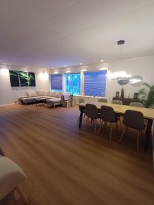 a large living room with a table and chairs at Private 4 bedroom getaway in Lofoten in Vestvågøya