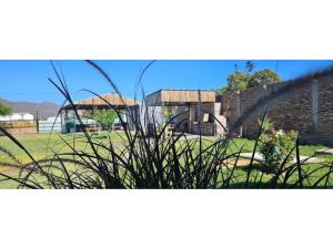 a view of a garden with grass and a building at Casa en Zonda in Zonda