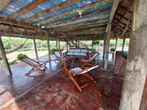 a porch with chairs and a table and a couch at Cabaña ecológica frente al mar en isla fuerte in Isla Fuerte