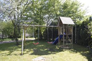 a playground with a slide and a swing at rikobravo in Meppen