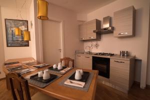 a kitchen with a wooden table and a dining room at Casa Del Jazz in Piazza Armerina