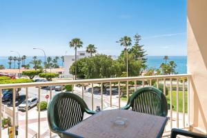 a table and chairs on a balcony with the ocean at Apartamentos Solset Nerja in Nerja