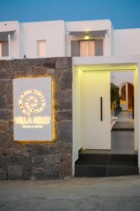 a building with a sign that reads willka kirkley at Villa Kelly Rooms & Suites in Naousa