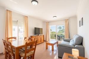 a living room with a couch and a table at Apartamentos Solset Nerja in Nerja