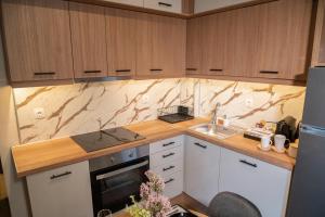 a kitchen with a sink and a counter top at Sandy'sLuxuryApartment in Alexandroupoli