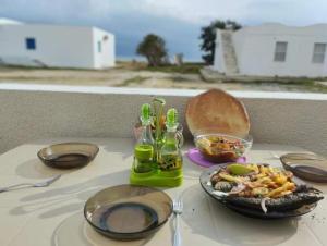 a table with a plate of food and a bowl of food at Ain grenz2 kelibia in Kelibia