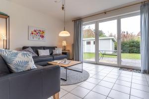 a living room with a couch and a table at Haus Eismöwe in Böhl