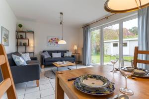 a living room with a couch and a table at Haus Eismöwe in Böhl +11 photos
