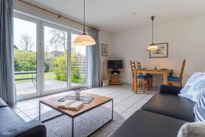 a living room with a couch and a table at Haus Eismöwe in Böhl