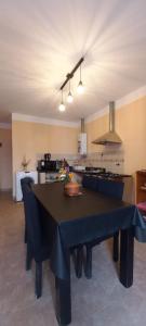 a dining room with a table and a kitchen at Casa Centro Tilcara in Tilcara