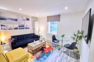 a living room with a couch and a table at Coastal Comfort for 5 in Portsmouth