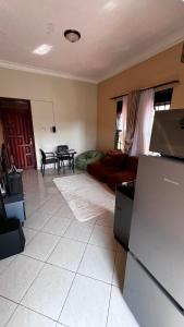 a living room with a couch and a table at Comfy Square in Kampala