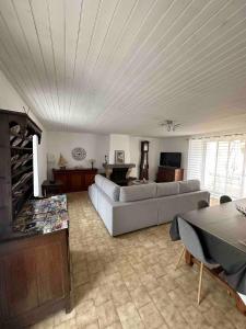 a living room with a couch and a table at Résidence agréable proche de la mer in Saint-Gervais +8 photos