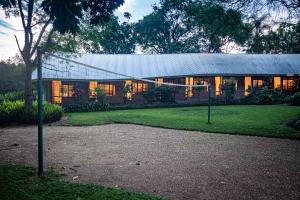 a large building with a gambrel roof at Ons Plek Accommodation in Hazyview