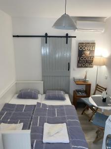 a bedroom with two beds and a table and a table at Apartman Zeljka in Pula