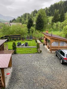 an aerial view of a house with a car parked in a driveway at Cabana La Batranu-ciubar&atv in Borşa