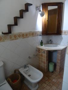 a bathroom with a toilet and a sink at Camera D'Ambra in Campiglia Marittima
