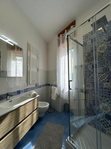 a bathroom with a shower and a sink and a toilet at Massi's House - Cozy & New in Maiori +18 photos