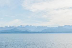 a large body of water with mountains in the background at Del Lago Sky Hotel in San Carlos de Bariloche