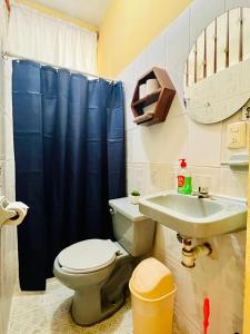 a bathroom with a toilet and a sink at Palmar la Punta 5 Starlink 2min walk to the beach in Brisas de Zicatela