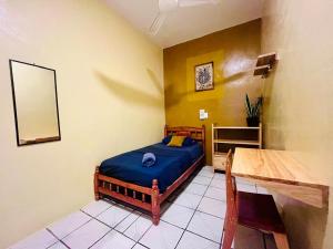 a bedroom with a bed and a table and a mirror at Palmar la Punta 5 Starlink 2min walk to the beach in Brisas de Zicatela