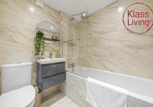 a bathroom with a toilet and a sink and a tub at Drumpellier Apartment by Klass Living Coatbridge in Coatbridge +26 photos