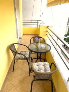 a small table and two chairs on a balcony at Ermes Center Apartment in Elbasan +9 photos
