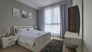 Ένα ή περισσότερα κρεβάτια σε δωμάτιο στο Axxodia- Apartments In Aeon Towers