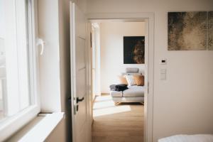 a hallway with a couch in a room at Apartmány DVĚ BOBULE 2KK in Pasohlávky