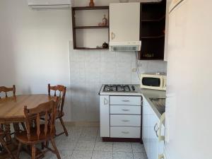 a kitchen with a table and a stove top oven at Green Apartment in Sreser +15 photos