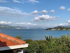 a view of the ocean with a bridge in the distance at Green Apartment in Sreser