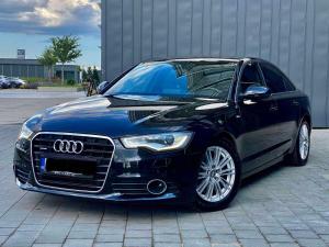 a black car parked in a parking lot at Albanian Car Hire in Rinas
