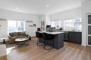 a kitchen and living room with a island in the middle at Chic Studio Close to Harbor Point in Stamford