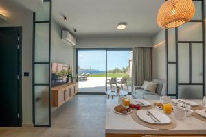 a living room with a table with food on it at Nusa Retreat - Seaview luxury residences in Kissamos