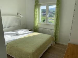a bedroom with a bed and a window at Vinka Apartment in Sreser