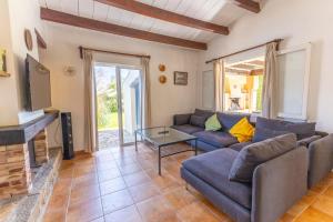 a living room with a couch and a table at Charming villa with A/C and WIFI in Pollença
