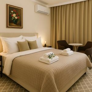a bedroom with a large bed with towels on it at Metropolis B2 -Γοητευτική Σουίτα in Athens